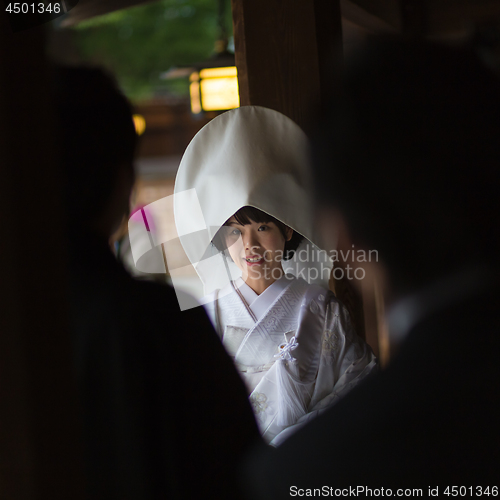 Image of Young happy groom and bride during japanese traditional wedding ceremony at Meiji-jingu shrine in Tokyo, Japan on November 23, 2013.