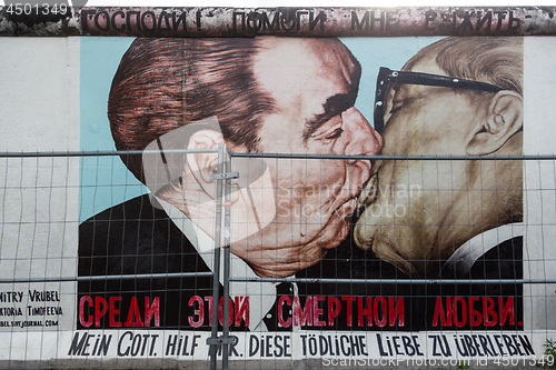 Image of The famous Fraternal kiss graffiti: My God, Help Me to Survive This Deadly Love by Dmitri Vrubel on the Berlin Wall in Berlin, Germany.