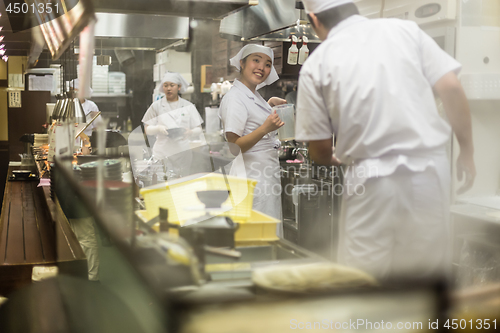 Image of Japanese Ramen chefs prepare a bowl of traditional home made ramen noodle for customers in Kyoto, Japan.