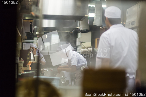 Image of Japanese Ramen chefs prepare a bowl of traditional home made ramen noodle for customers in Kyoto, Japan.