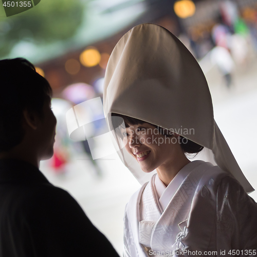 Image of Young happy groom and bride during japanese traditional wedding ceremony at Meiji-jingu shrine in Tokyo, Japan on November 23, 2013.