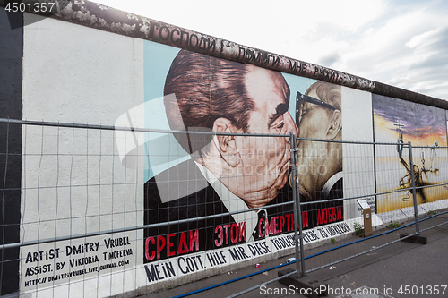 Image of The famous Fraternal kiss graffiti: My God, Help Me to Survive This Deadly Love by Dmitri Vrubel on the Berlin Wall in Berlin, Germany.