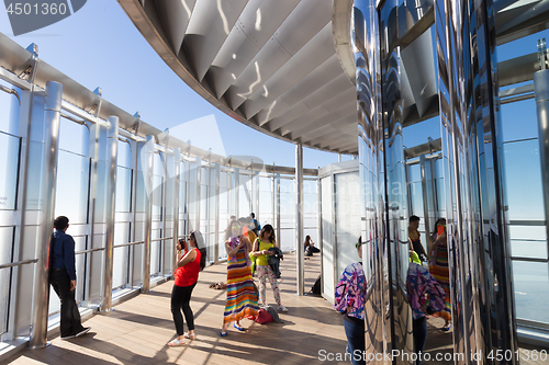 Image of Tourists taking photos at the top the observation deck of the highest building in the world,Burj Khalifa in Dubai, UAE