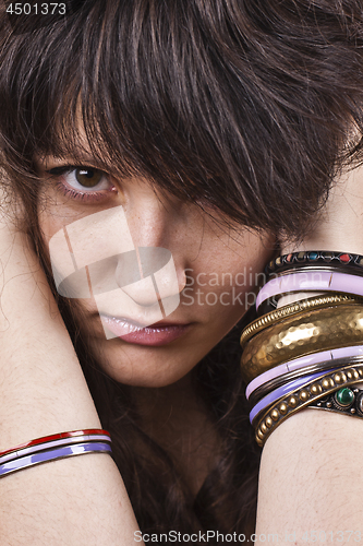 Image of Brunet woman with bracelets.