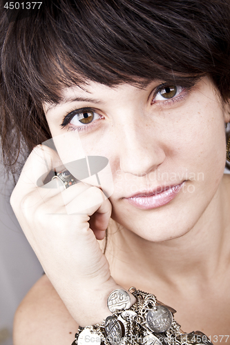 Image of Brunette lady with bracelets.