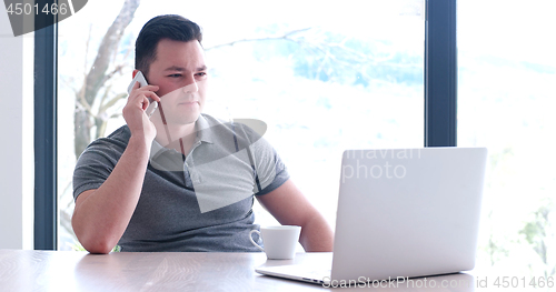 Image of businessman working using a laptop in startup office