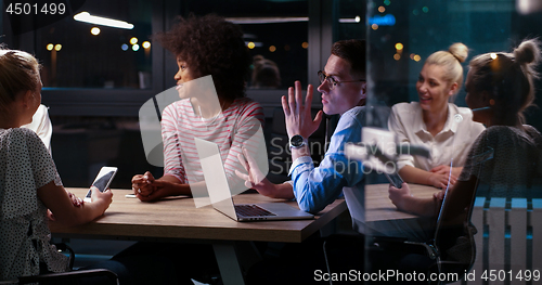 Image of Multiethnic startup business team in night office