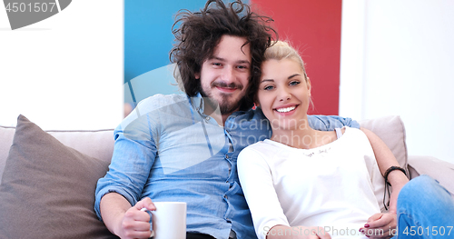 Image of Young couple on the sofa watching television