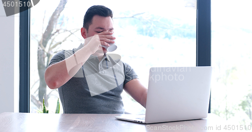 Image of businessman working using a laptop in startup office