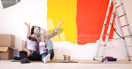 Image of Happy young couple relaxing after painting