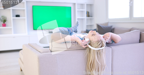 Image of girl enjoying music through headphones