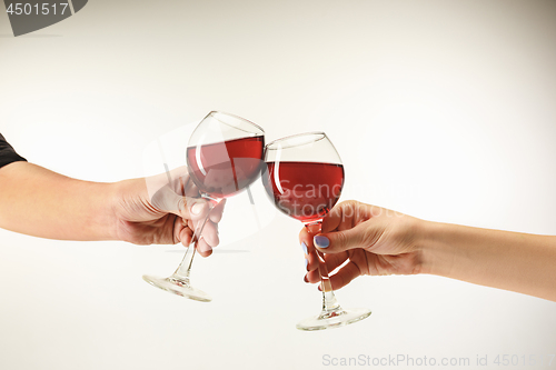 Image of Hands with glasses of red wine, isolated on white
