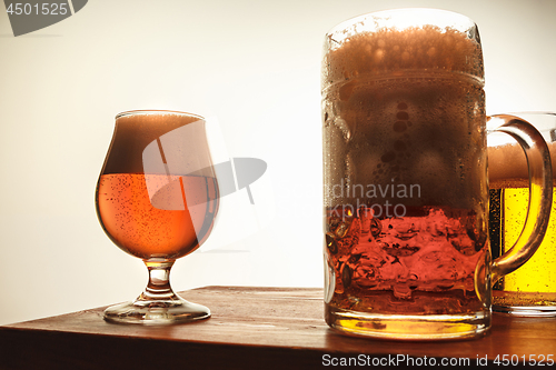 Image of The two mugs of beer on table background