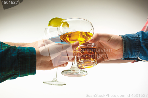 Image of The male and female hands with exotic cocktails