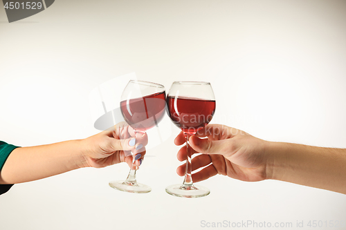 Image of Hands with glasses of red wine, isolated on white