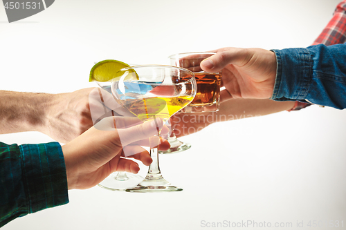 Image of The male and female hands with exotic cocktails