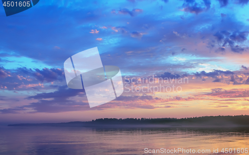 Image of Amazing Sunset Over The Forested Shore Of The Lake