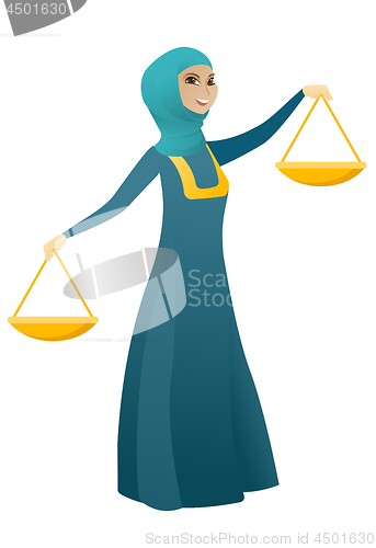 Image of Muslim business woman holding balance scale.