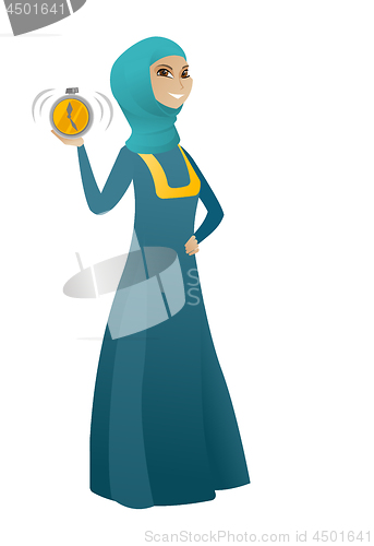 Image of Muslim business woman holding alarm clock.