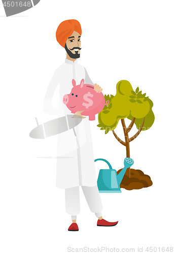 Image of Hindu farmer holding a piggy bank.