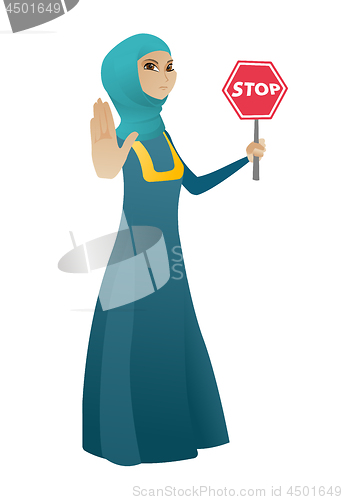 Image of Muslim business woman holding stop road sign.