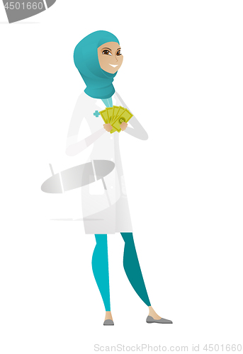 Image of Happy muslim doctor holding money.