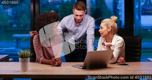 Image of Multiethnic startup business team in night office