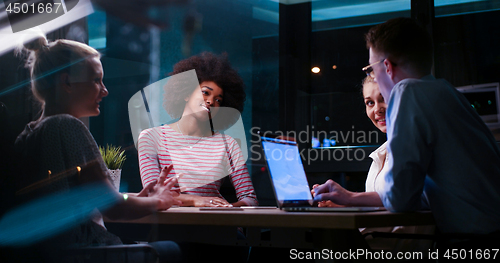 Image of Multiethnic startup business team in night office