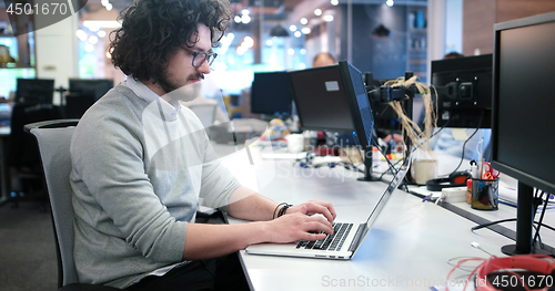 Image of businessman working using a laptop in startup office
