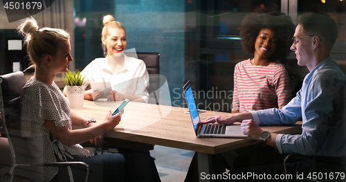 Image of Multiethnic startup business team in night office