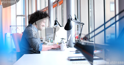 Image of businessman working using a laptop in startup office