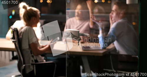 Image of Multiethnic startup business team in night office