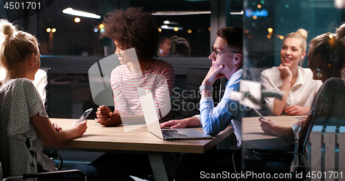 Image of Multiethnic startup business team in night office