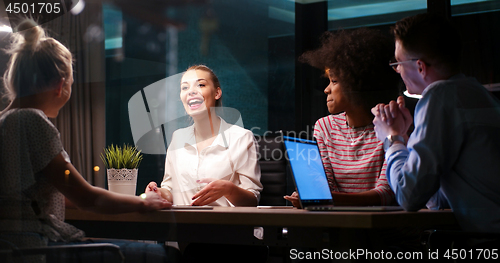 Image of Multiethnic startup business team in night office