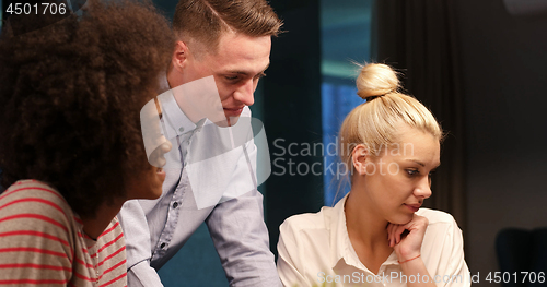 Image of Multiethnic startup business team in night office