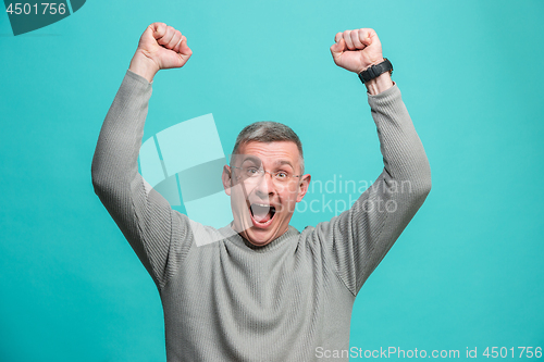 Image of Winning success man happy ecstatic celebrating being a winner. Dynamic energetic image of male model