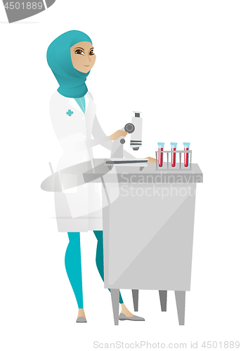 Image of Laboratory assistant working with microscope.