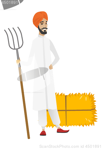 Image of Young hindu farmer holding a pitchfork.