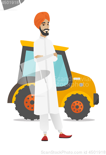 Image of Farmer standing on the background of tractor.