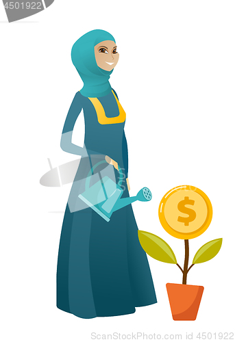 Image of Muslim business woman watering money flower.