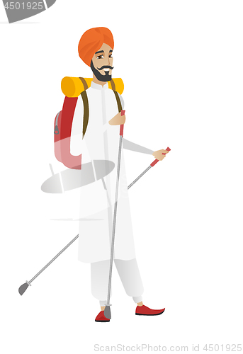 Image of Hindu man hiker walking with trekking sticks.