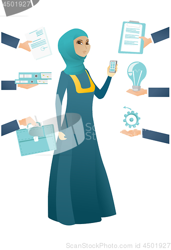 Image of Muslim business woman having lots of work to do.