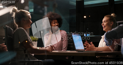 Image of Multiethnic startup business team in night office