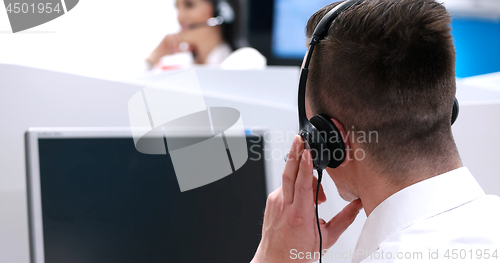 Image of male call centre operator doing his job