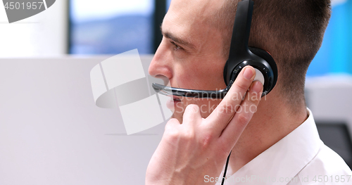 Image of male call centre operator doing his job