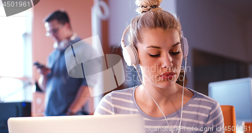 Image of businesswoman using a laptop in startup office