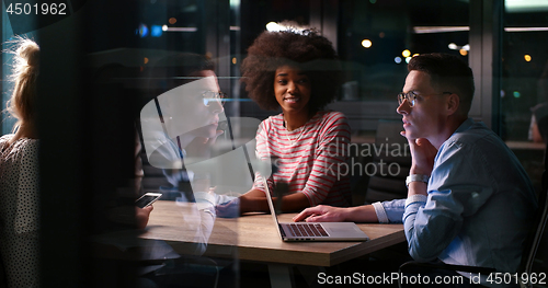 Image of Multiethnic startup business team in night office