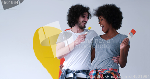 Image of couple with painted heart on wall
