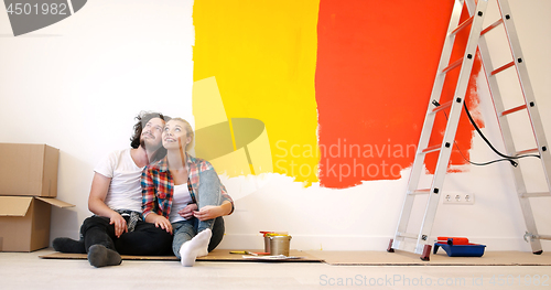 Image of Happy young couple relaxing after painting