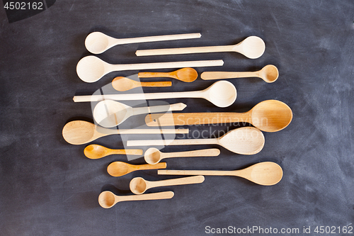 Image of Wooden spoons on blackboard background. 